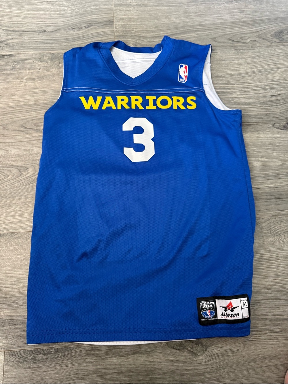 This is a blue and yellow youth-size Alleson Athletic Golden State Warriors #3